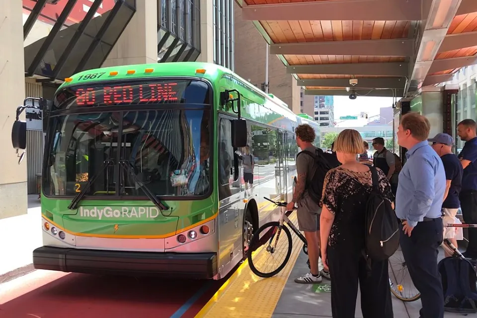 Passengers line up to board a bus at a bus rapid transit station in Indianapolis.